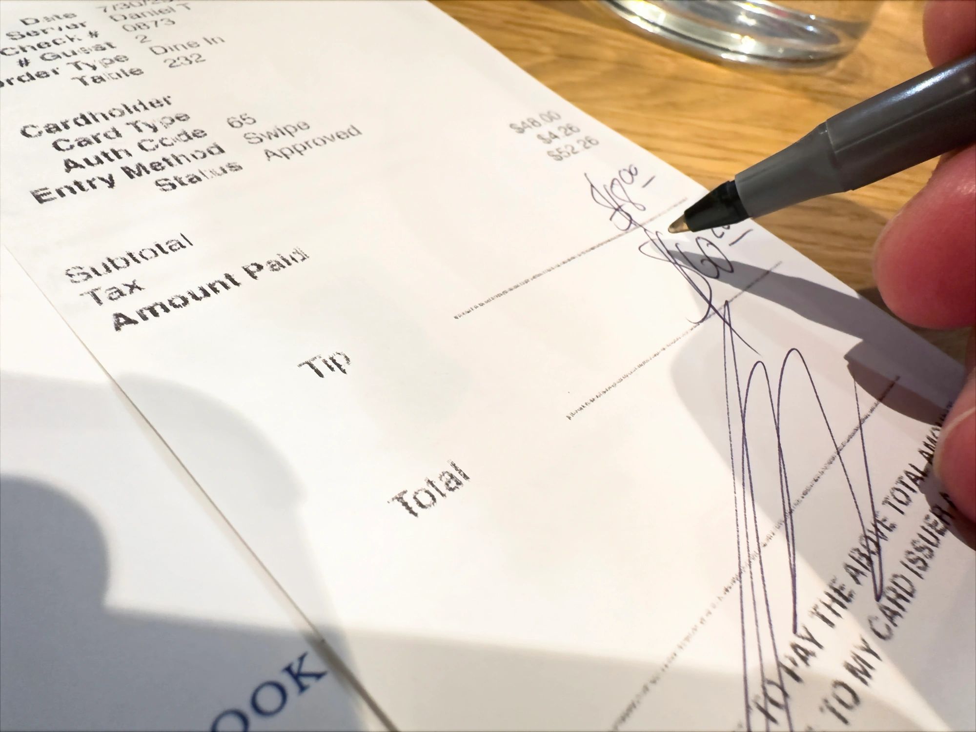 Signing a restaurant bill